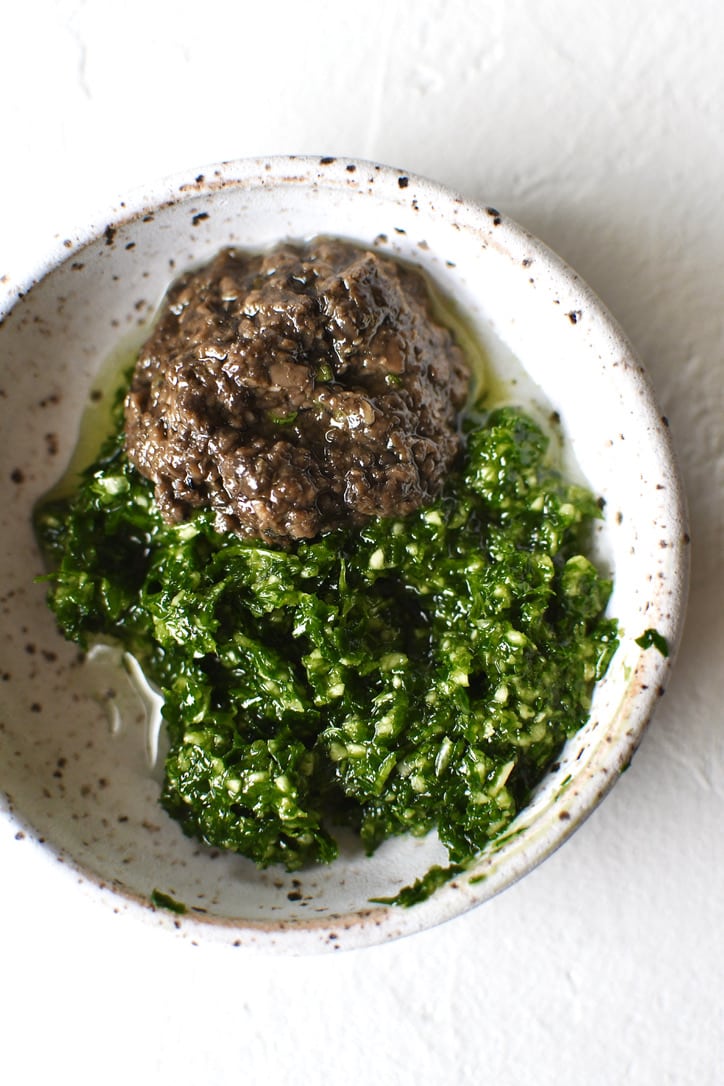 Truffle, garlic, parsley, and white truffle oil, together in a bowl.