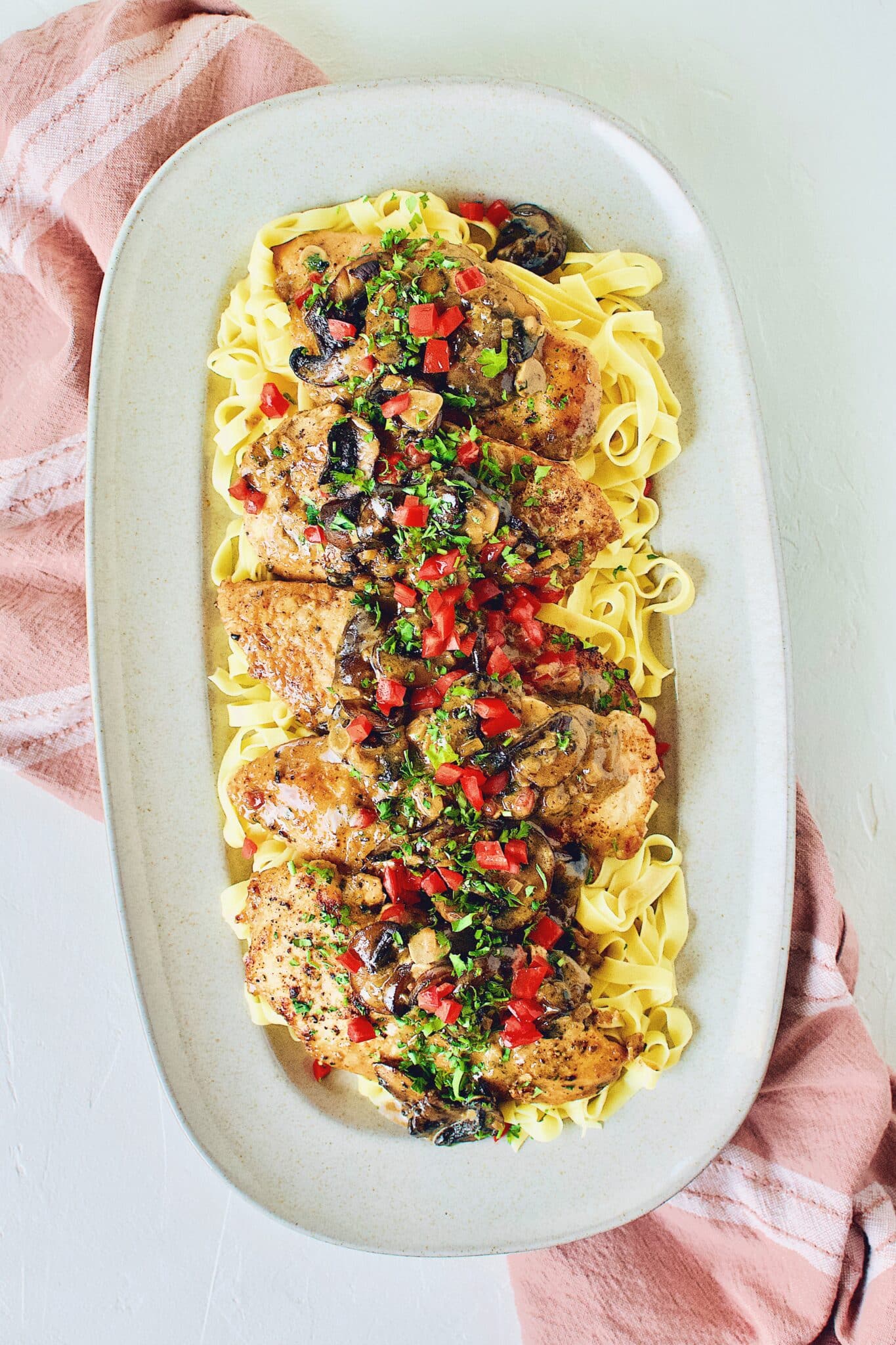 Creamy Chicken and Mushrooms served on a bed of fresh homemade pasta.
