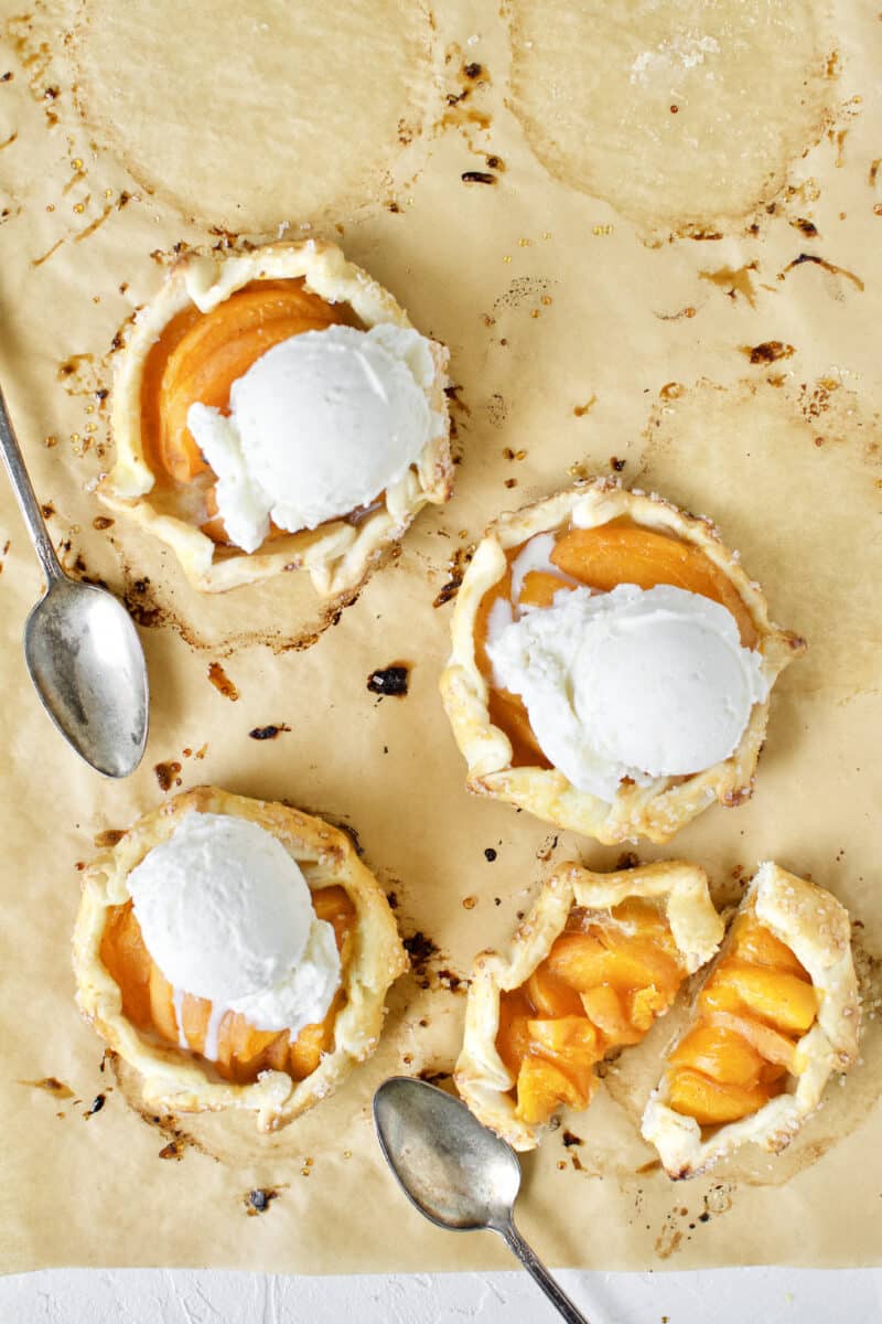 Apricot Pies fresh out of the oven, topped with vanilla ice cream.