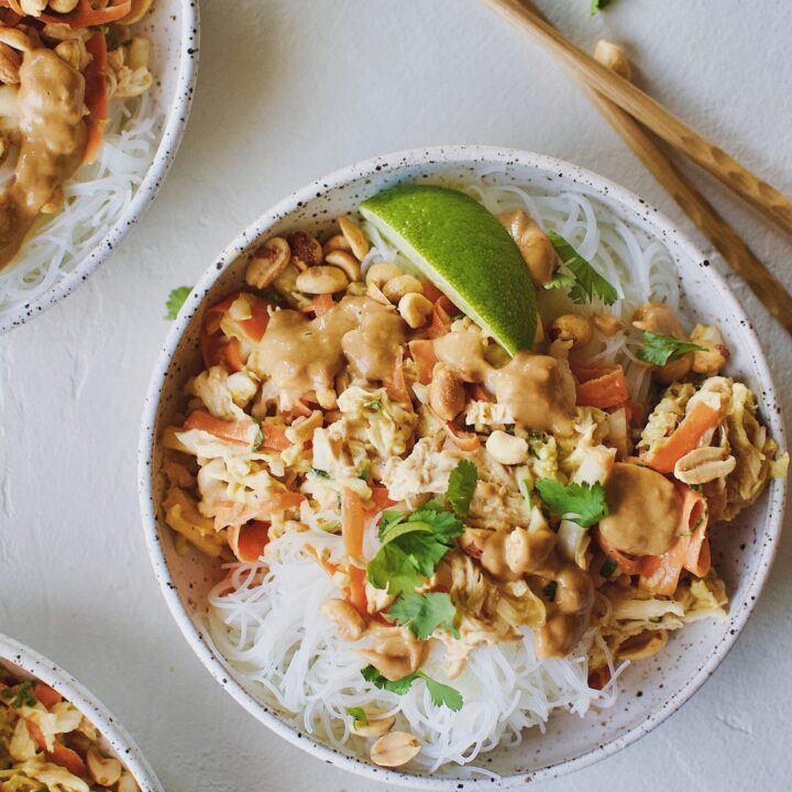 Asian Noodle Salad with Chicken in a noodle bowl and chopsticks on the side.