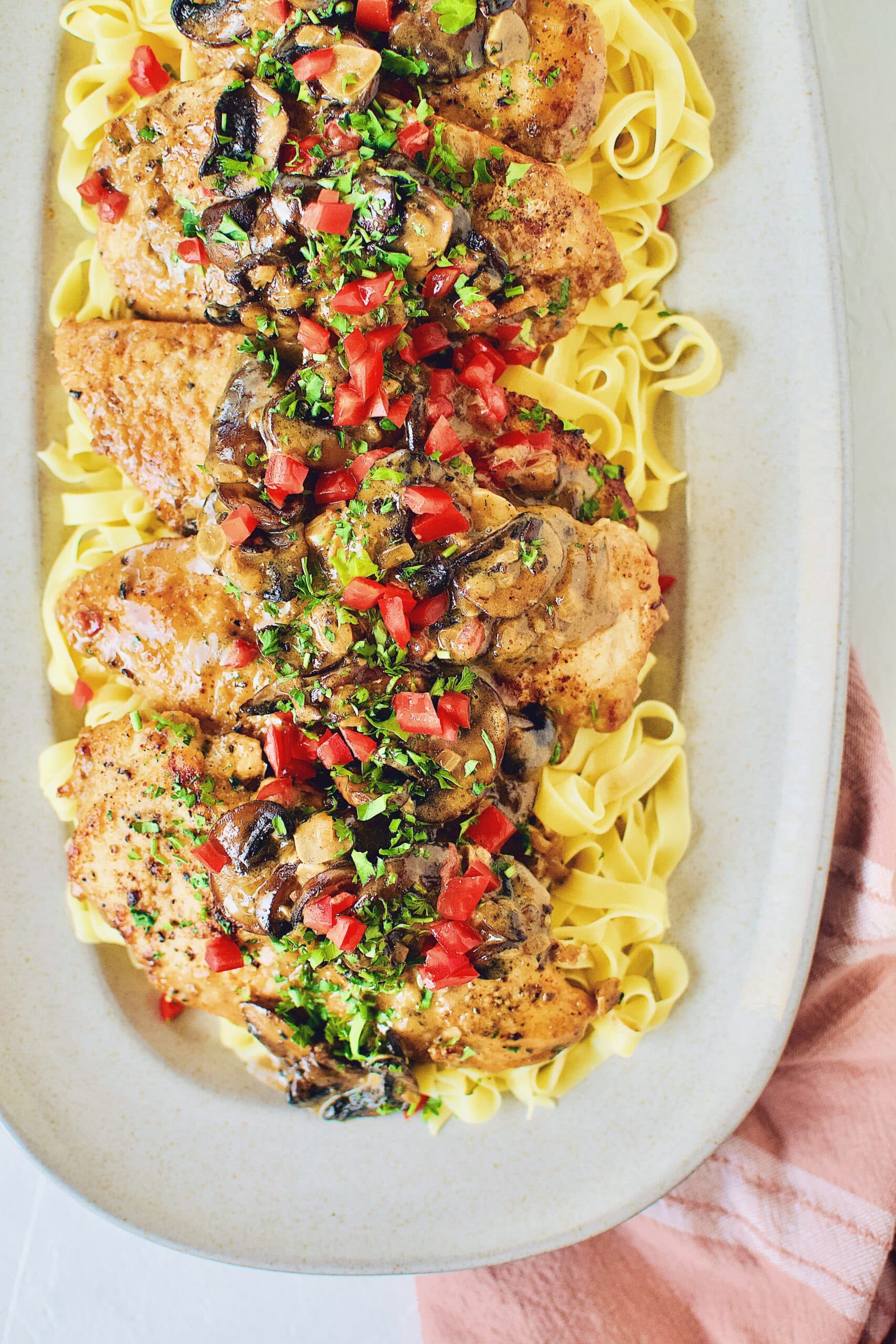 Creamy Chicken and Mushrooms served on a bed of fresh homemade pasta.