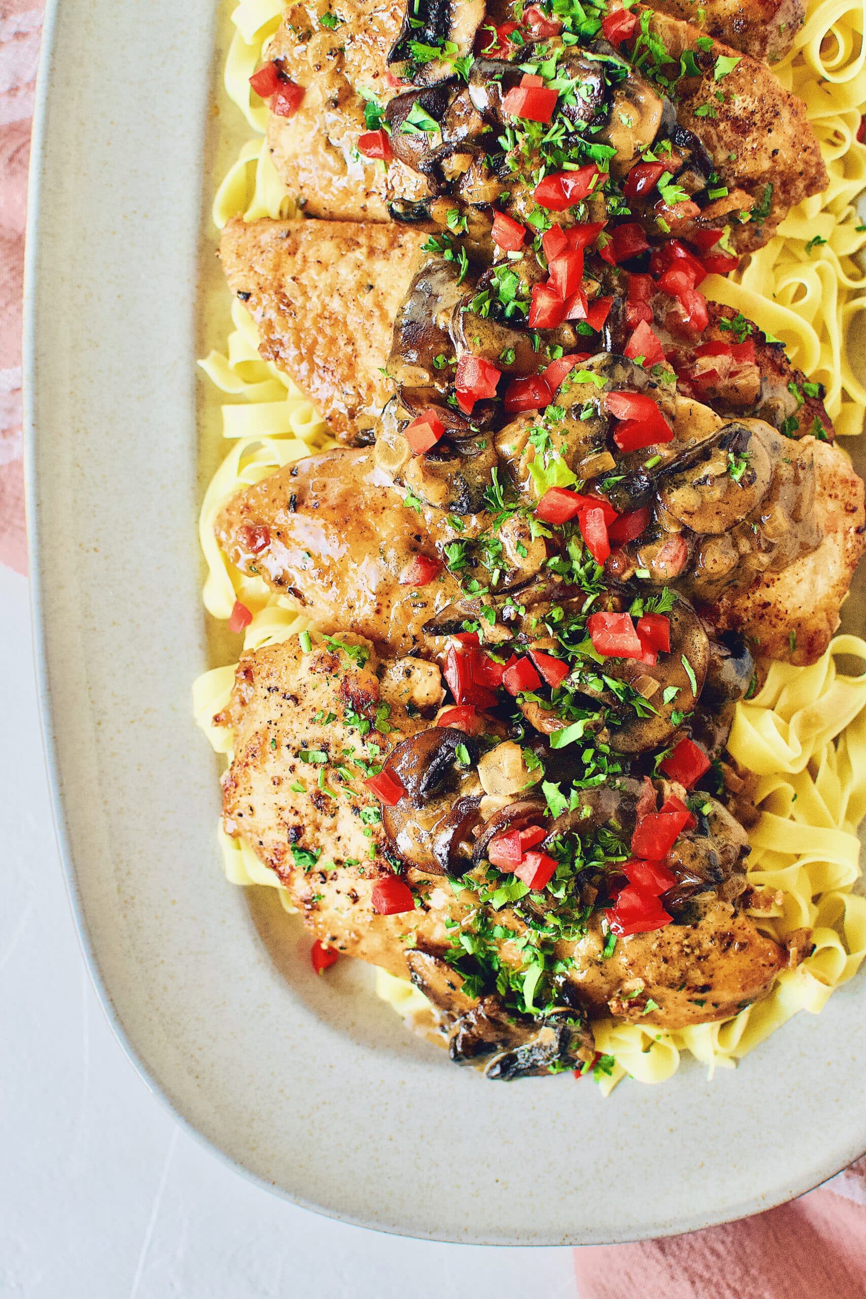 Creamy Chicken and Mushrooms served on a bed of fresh homemade pasta.