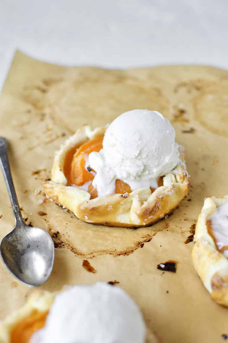 Apricot Pies fresh out of the oven, topped with vanilla ice cream.