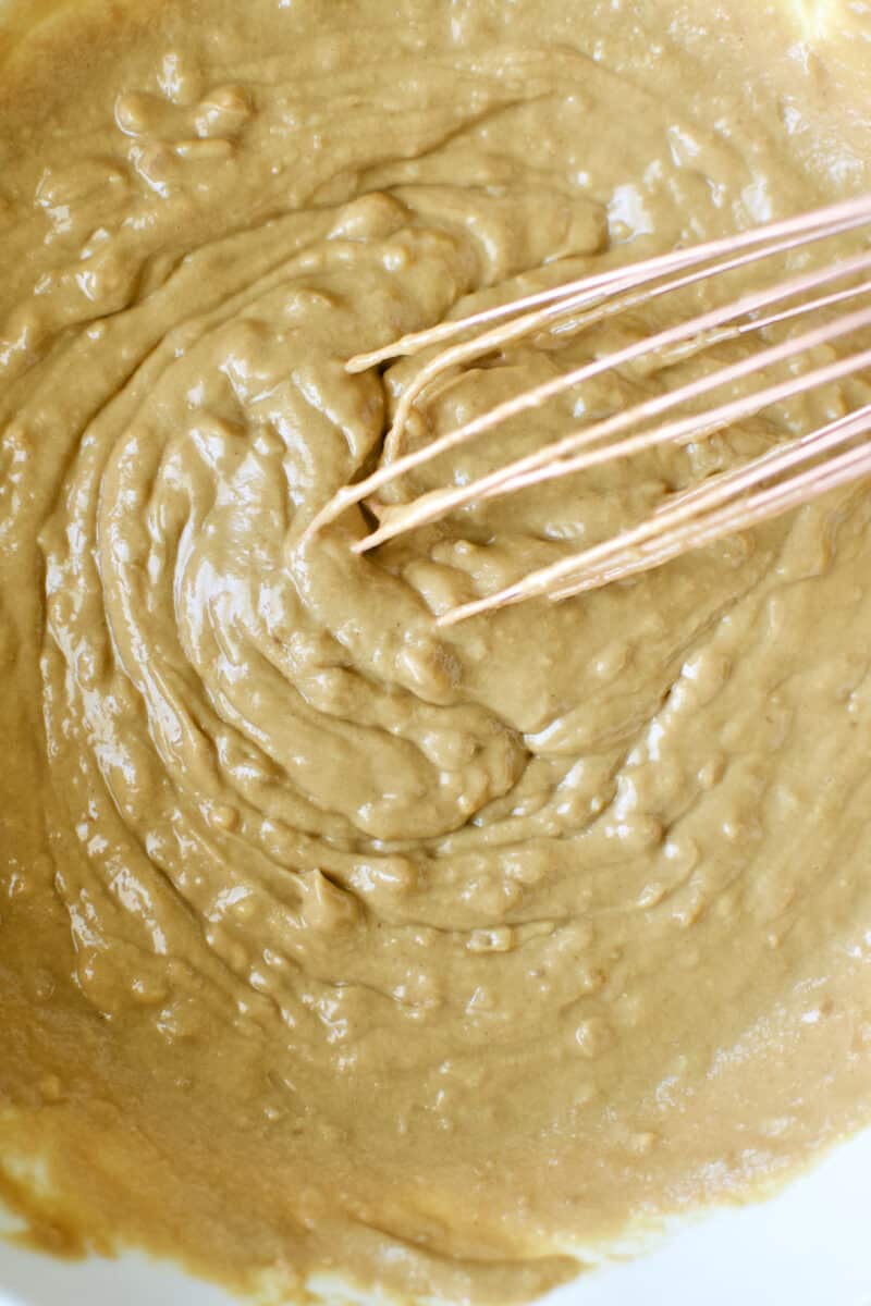 Whisking together the peanut dressing.