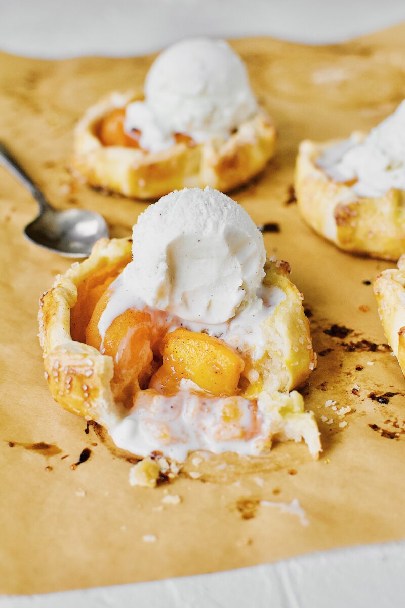 Apricot Pies fresh out of the oven, topped with vanilla ice cream.