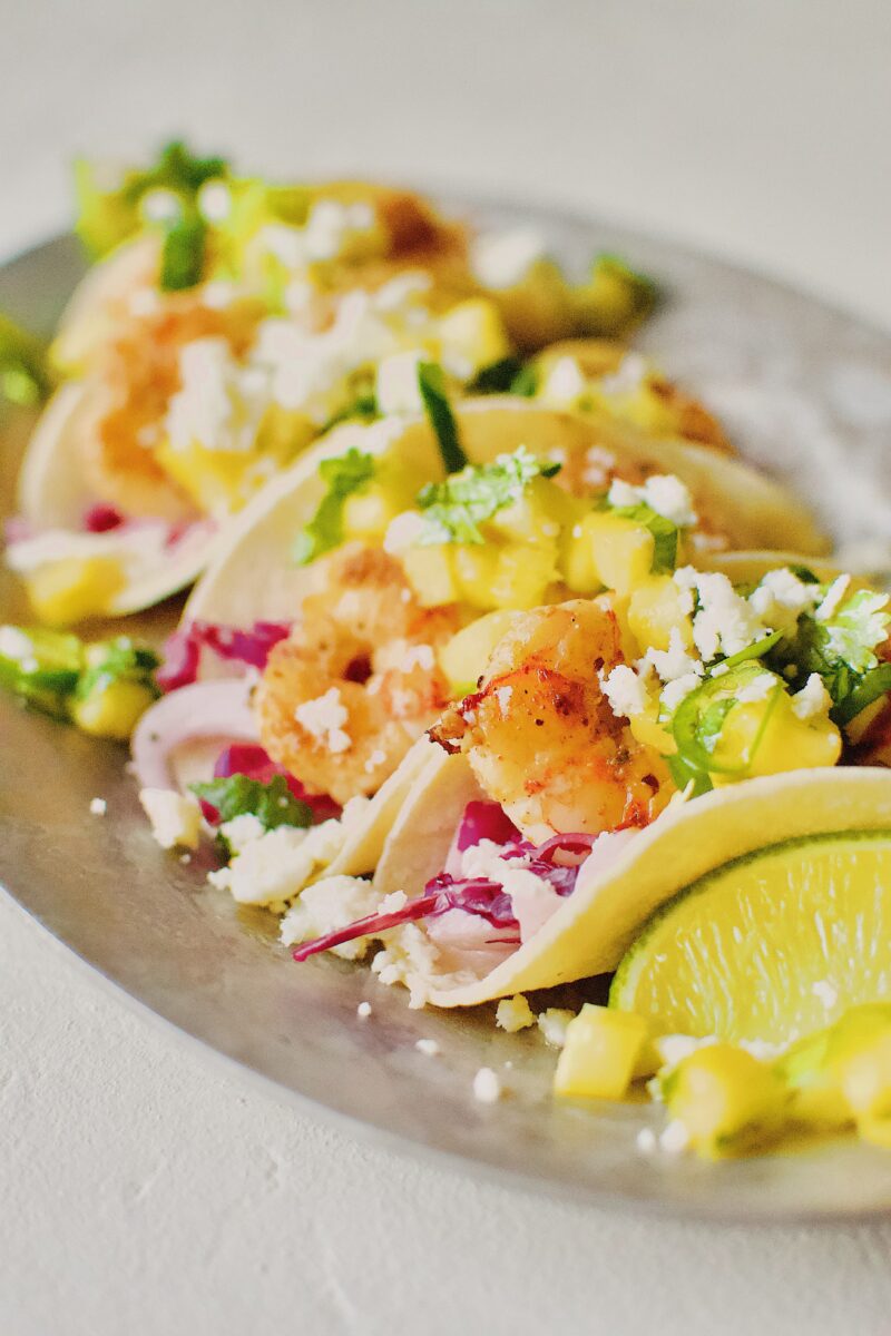 Baja Shrimp Tacos on a platter with all the toppings.