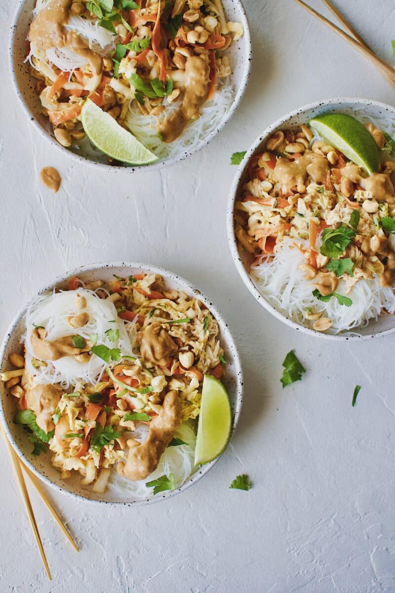 Asian Noodle Salad with Chicken in a noodle bowl and chopsticks on the side.