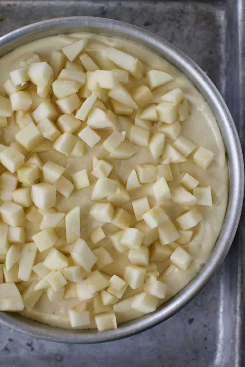 Diced apples placed on top of the cheesecake batter before baking.