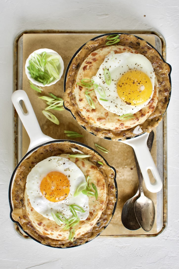 Breakfast Pie ready to eat. Topped with a fried egg and green onions.