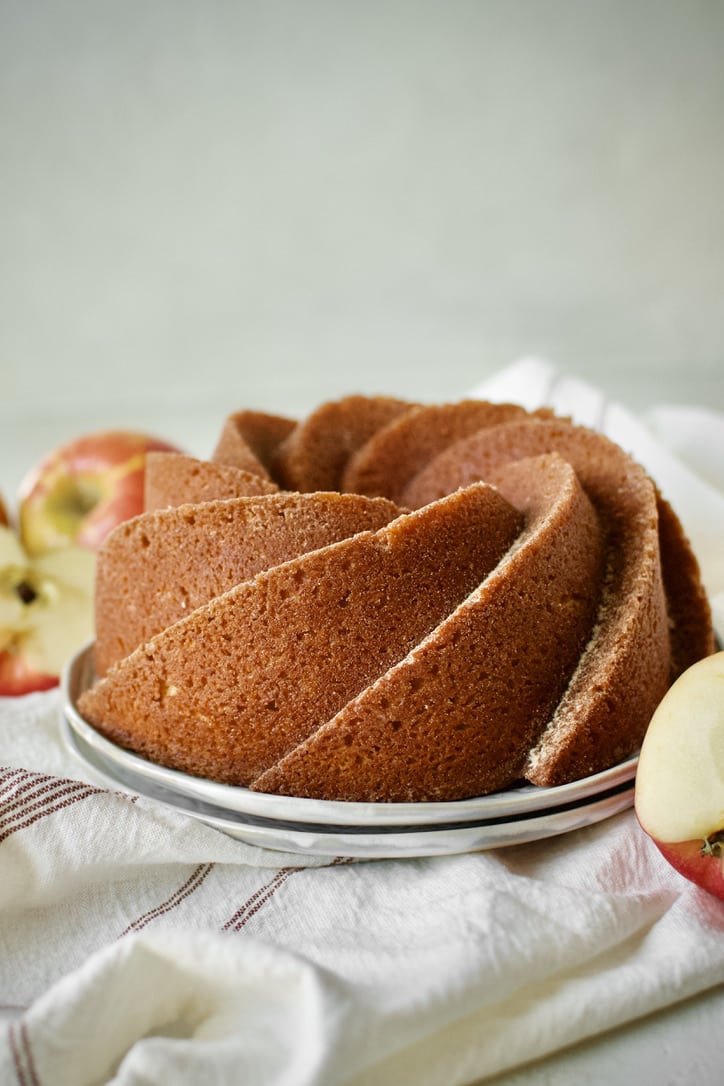 Apple Cider Donut Cake, after being brushed with cider syrup and dusted with spiced sugar.