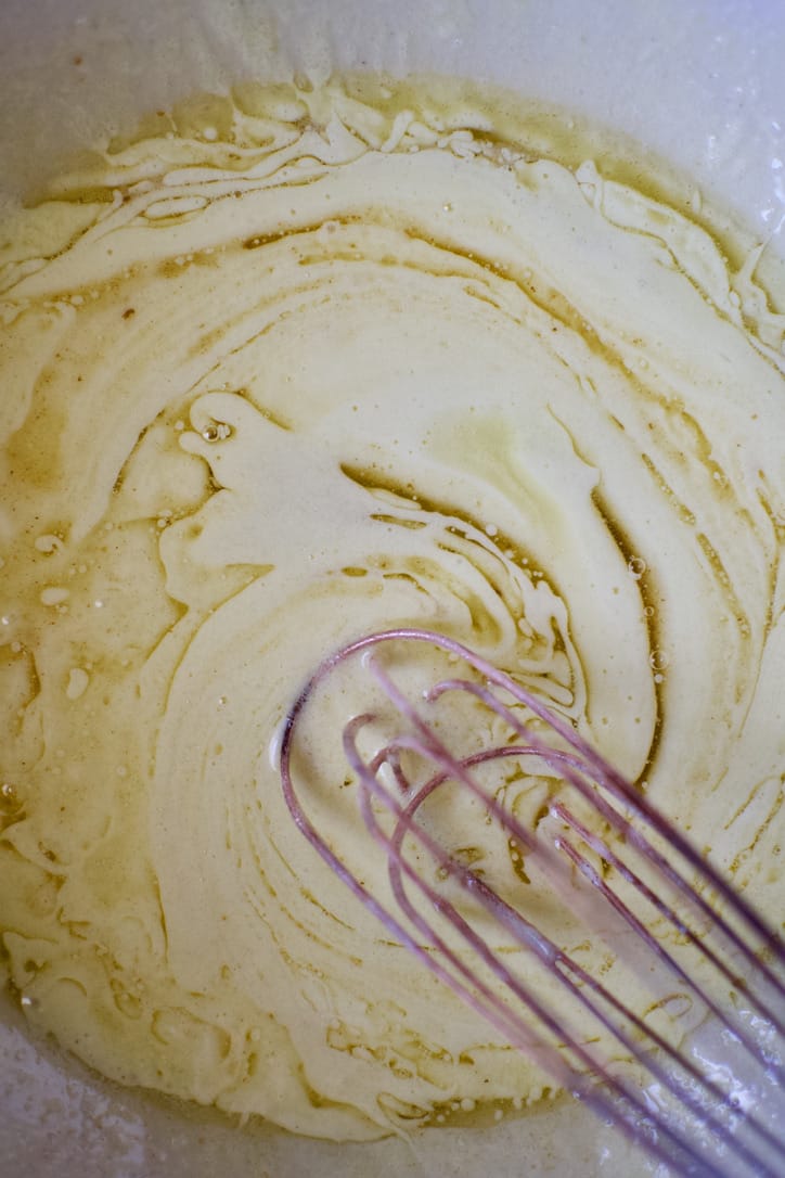 Whisking in the brown butter into the foamy eggs and sugar.