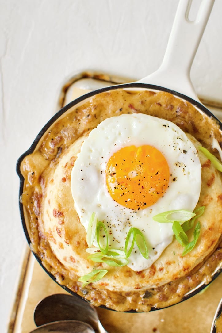 Breakfast Pie ready to eat. Topped with a fried egg and green onions.