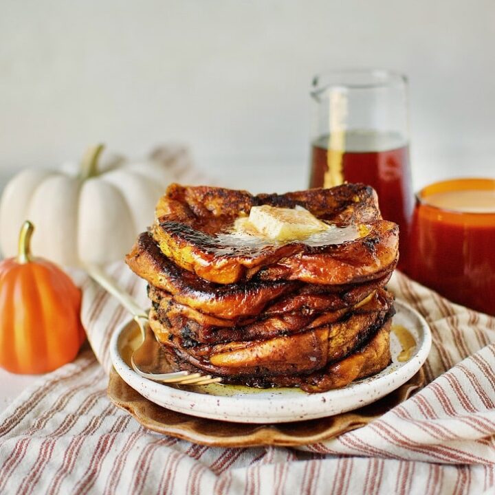 Pumpkin French Toast ready to eat topped with butter and pure maple syrup.