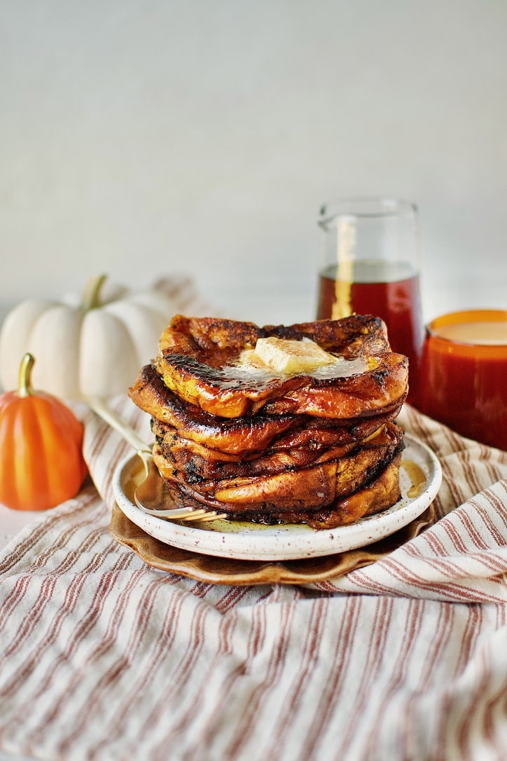 Pumpkin French Toast ready to eat topped with butter and pure maple syrup.