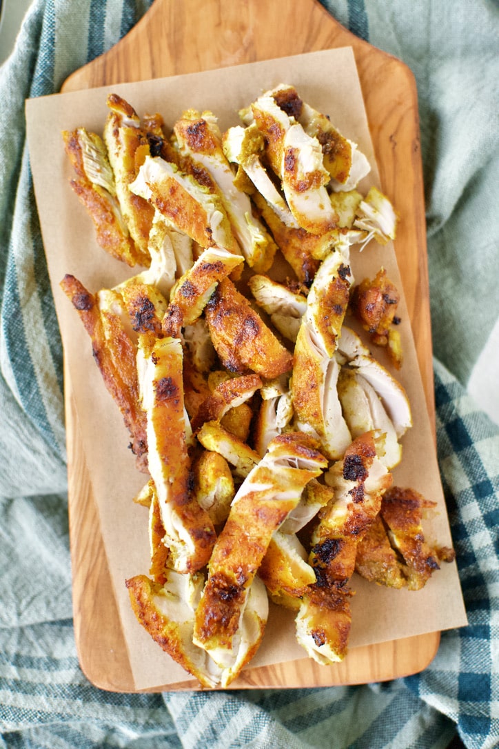 Chicken Shawarma sliced and on a board after cooking.