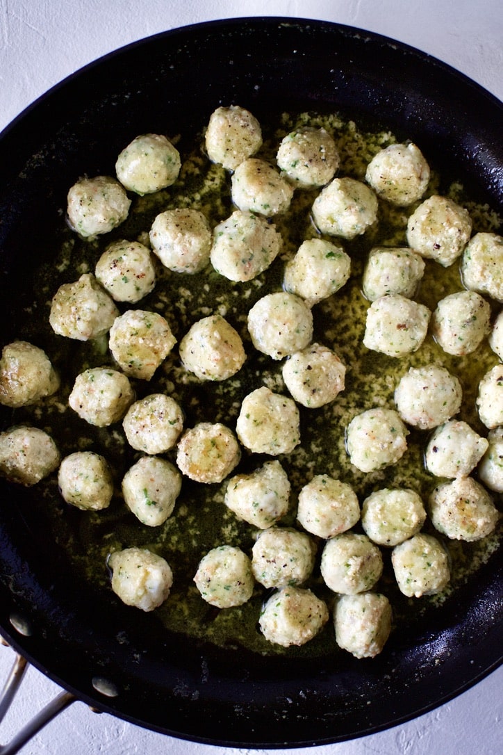 Shrimp Balls cooking in a pan with butter and garlic.