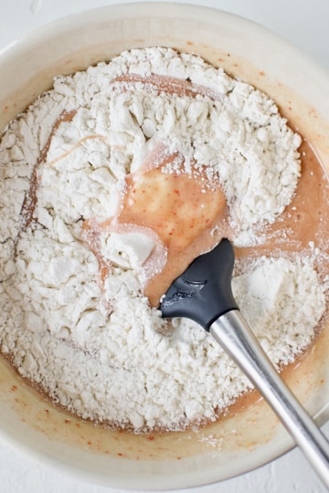 Folding in the flour to the ruby chocolate brownie batter.