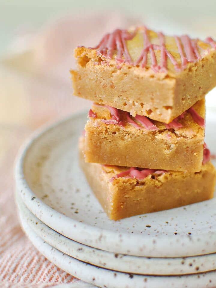 Ruby Chocolate Brownies stacked on a plate.