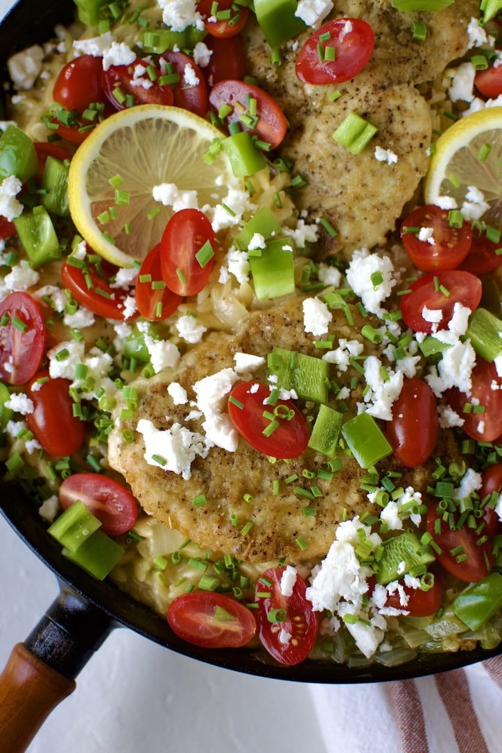 Lemon Orzo Chicken with Feta and Tomatoes finished and ready to serve in the pan.