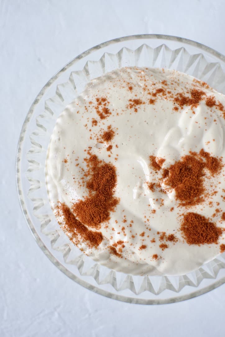 Garlic Sauce in a bowl topped with Paprika.