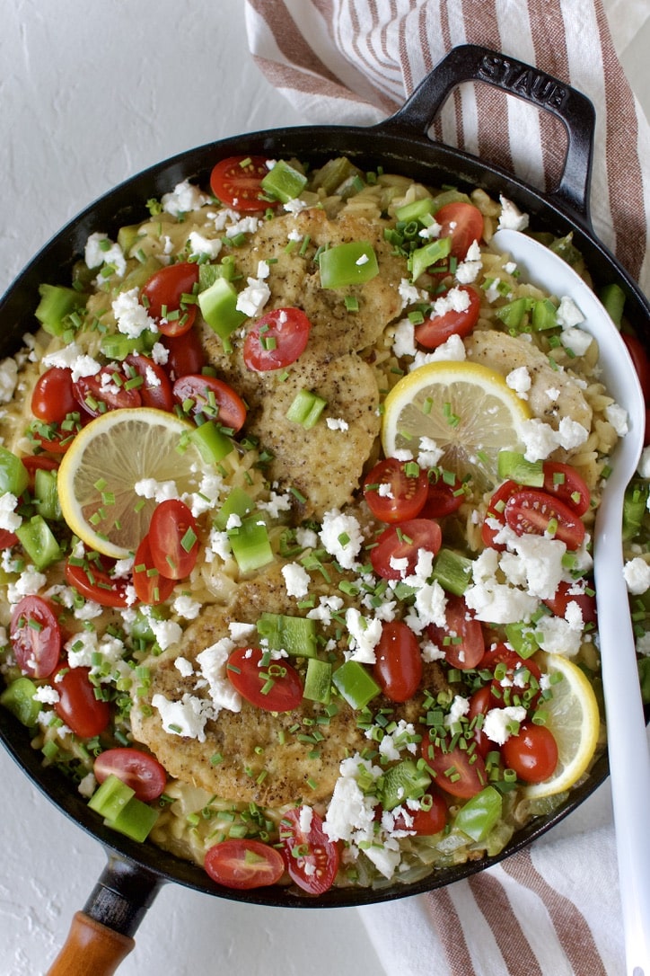 Lemon Orzo Chicken with Feta and Tomatoes finished and ready to serve in the pan.