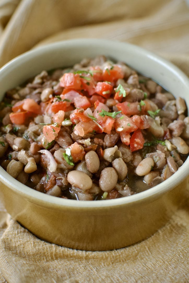 Pressure Cooker Pinto Beans in a bowl ready to eat. Topped with some Pico de Gallo.
