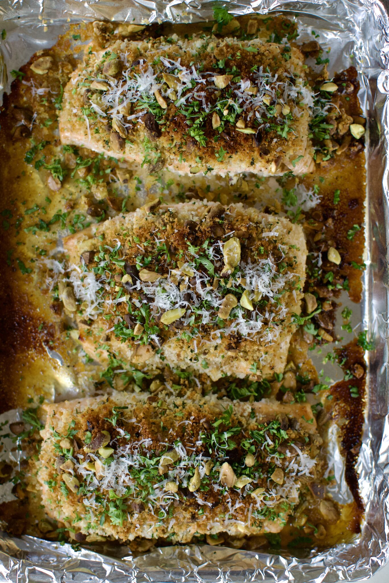 Pistachio Crusted Salmon fresh out of the oven, topped with parsley and parmesan.