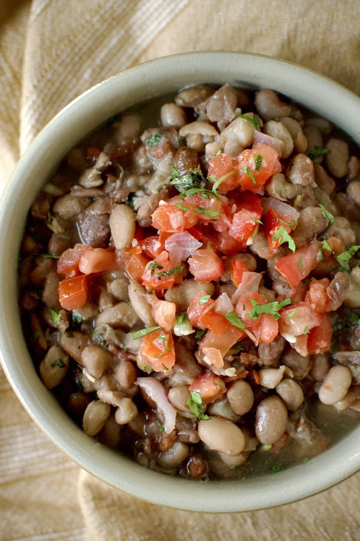 Pressure Cooker Pinto Beans in a bowl ready to eat. Topped with some Pico de Gallo.