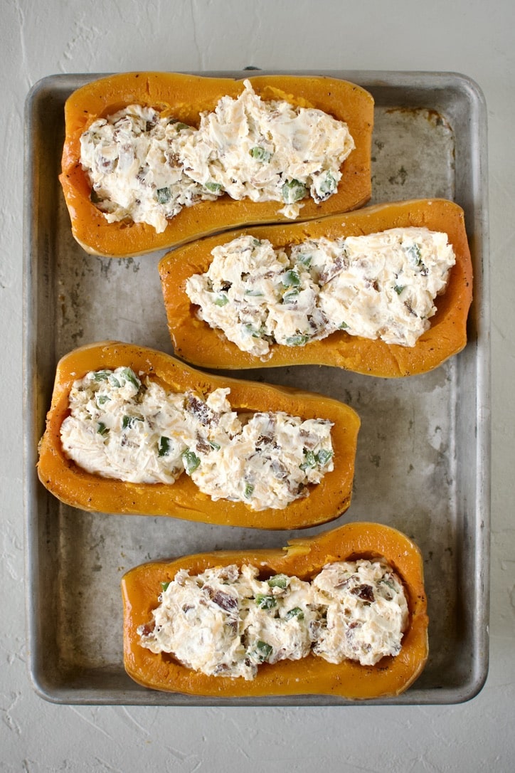 Adding the stuffing to the squash.