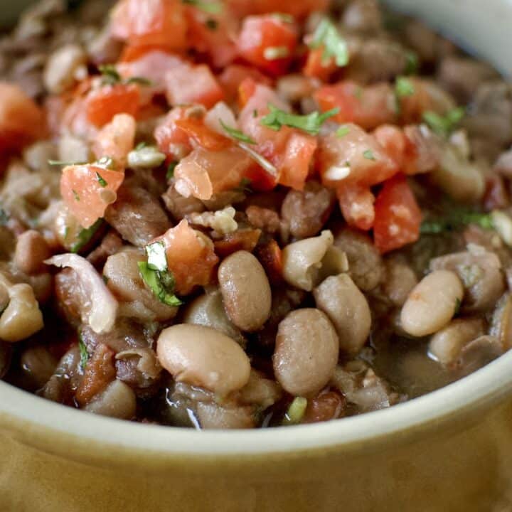 Pressure Cooker Pinto Beans in a bowl ready to eat. Topped with some Pico de Gallo.