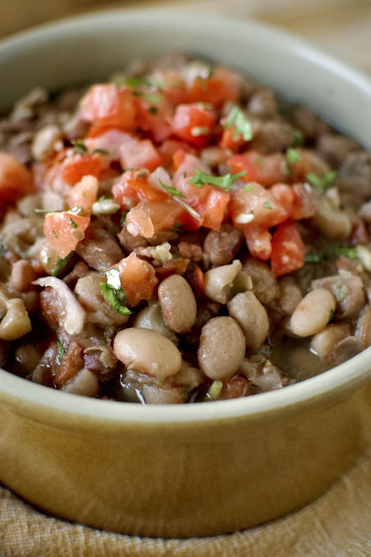 Pressure Cooker Pinto Beans in a bowl ready to eat. Topped with some Pico de Gallo.