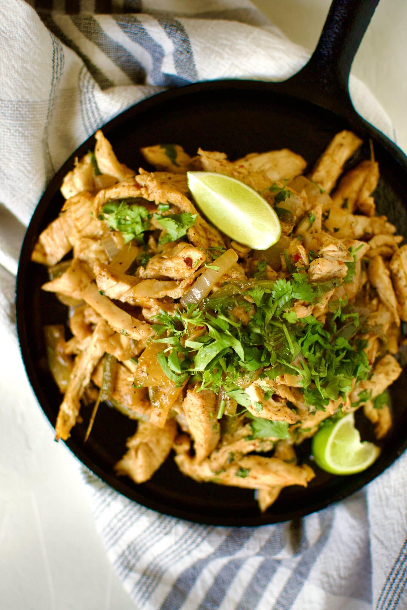 Easy Chicken Fajitas sizzling on a cast iron platter.