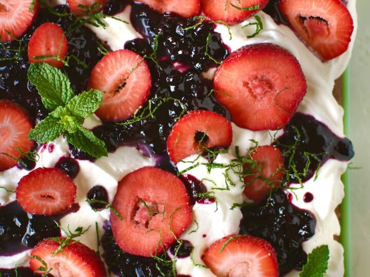 garnishing the tres leches with mint leaves and sliced mint.