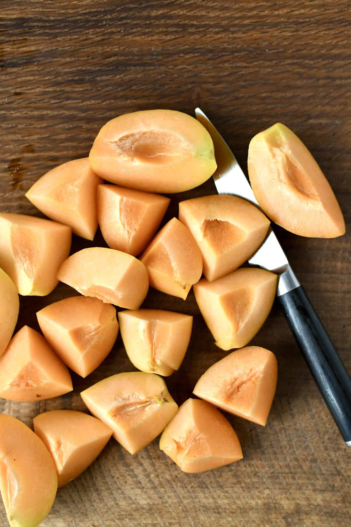 Apricots diced on a cutting board.