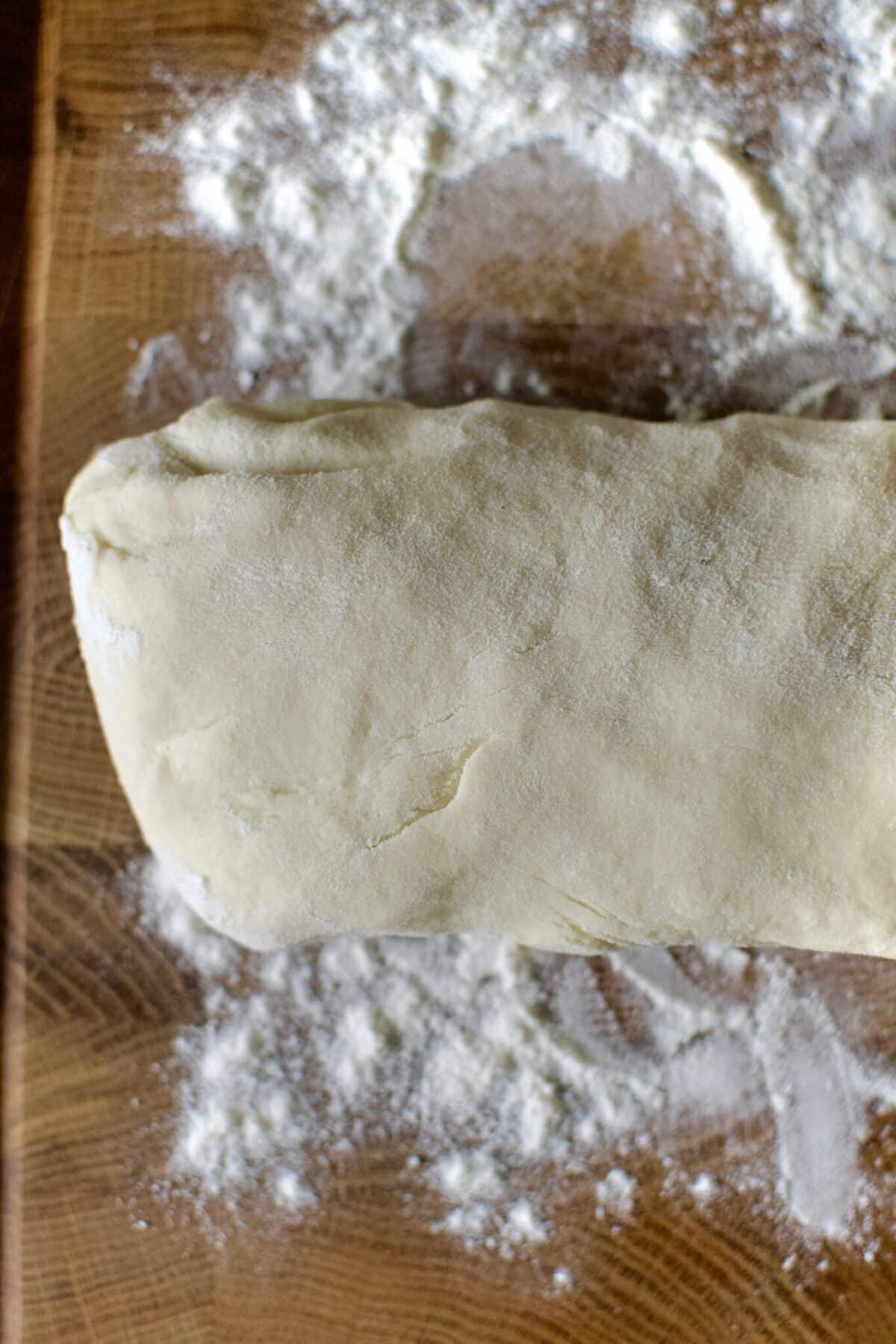 tortilla dough rolled out into a log.