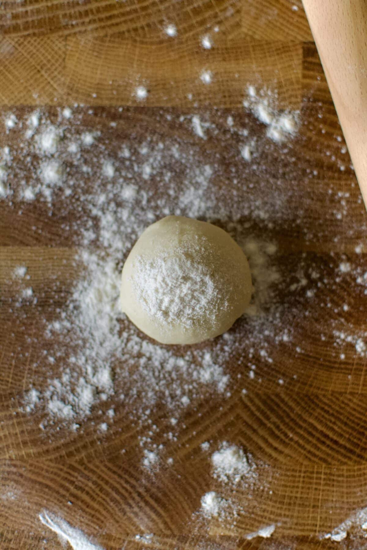 Flour dusted portion of tortilla dough ready to be rolled out.