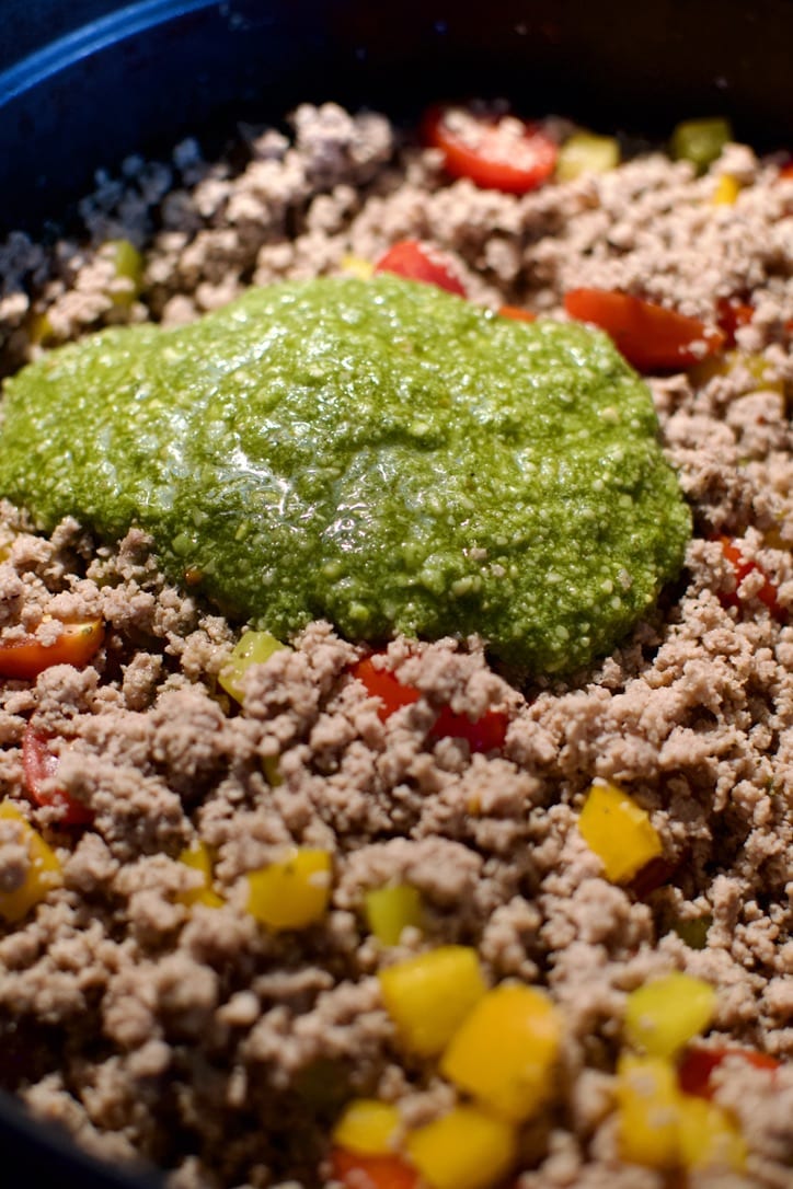 Pesto added to the ground turkey and veggie mixture.