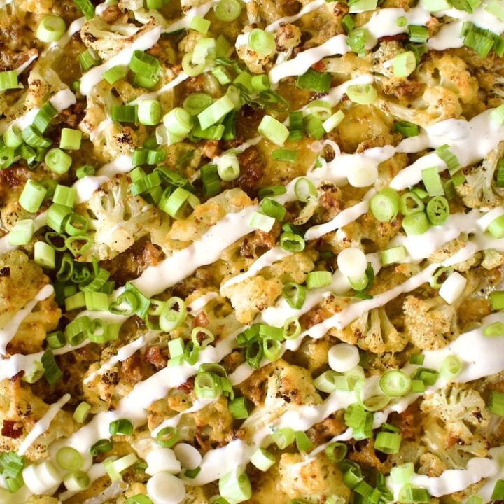 Loaded Baked Cauliflower on a sheet pan after cooking, ready to eat.