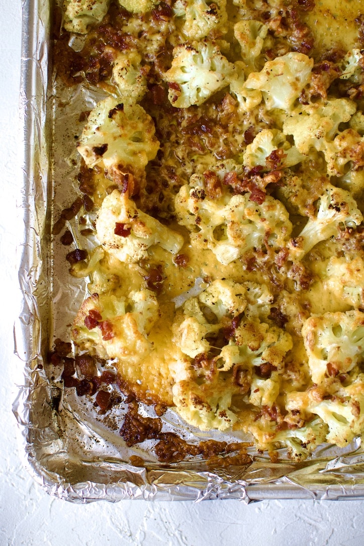 Cauliflower florets after roasting and broiling with bacon and cheddar crisped.