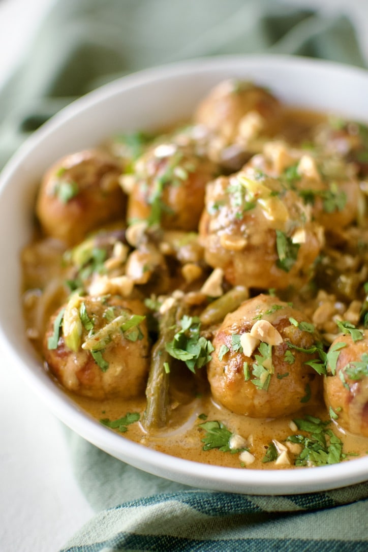 Ground Chicken Meatballs in Red Curry Sauce, served over rice noodles, in a bowl ready to eat.