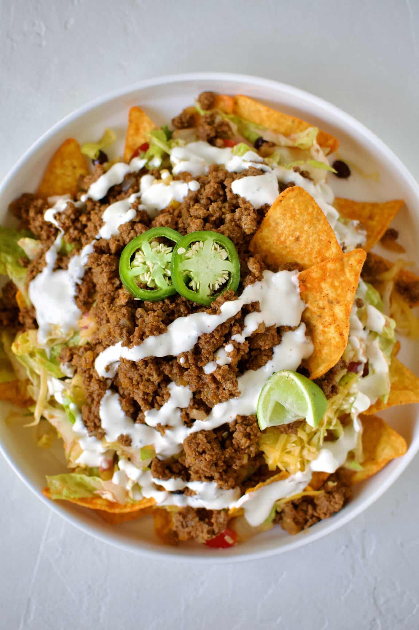 Taco Salad Recipe with Doritos on a large plate ready to eat.