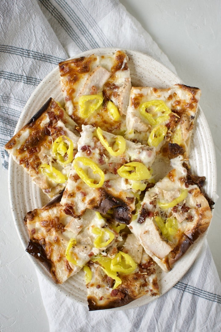 White Pizza Recipe fresh out of the oven and cut into pieces and placed on a platter.