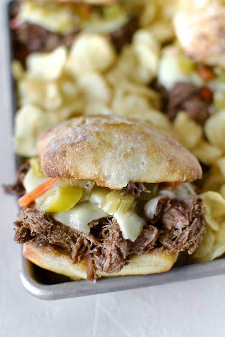 Italian Beef Sandwiches Recipe on a platter with chips ready to eat.