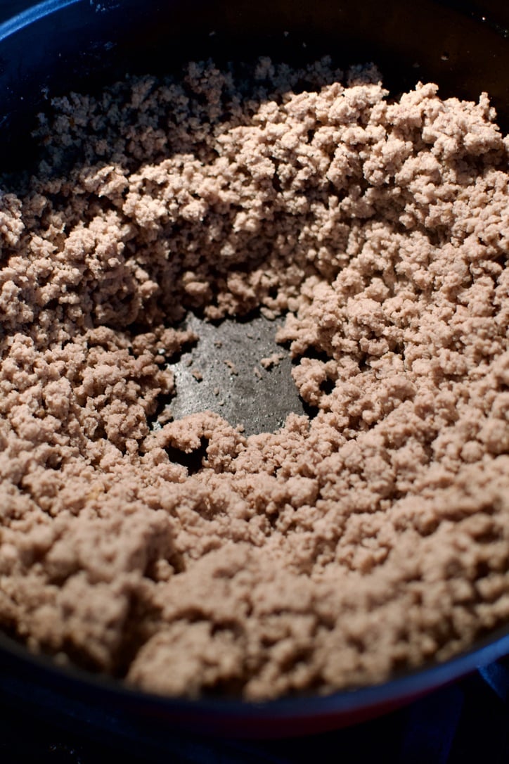 Browned ground turkey in a large pot, after draining off the excess liquid.