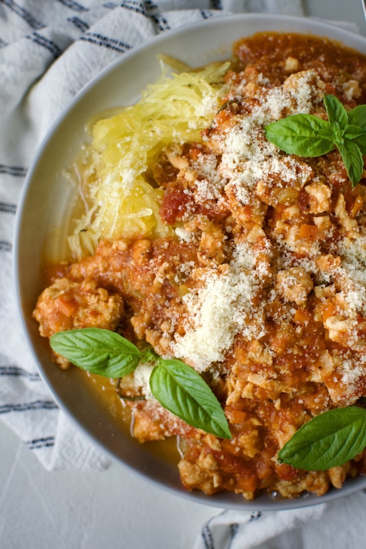 Chicken Ragu over Spaghetti Squash Nests on a plate ready to eat.