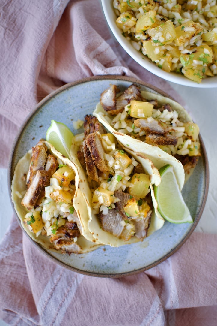 Al Pastor Taco Recipe in homemade corn tortillas topped with pineapple salsa.