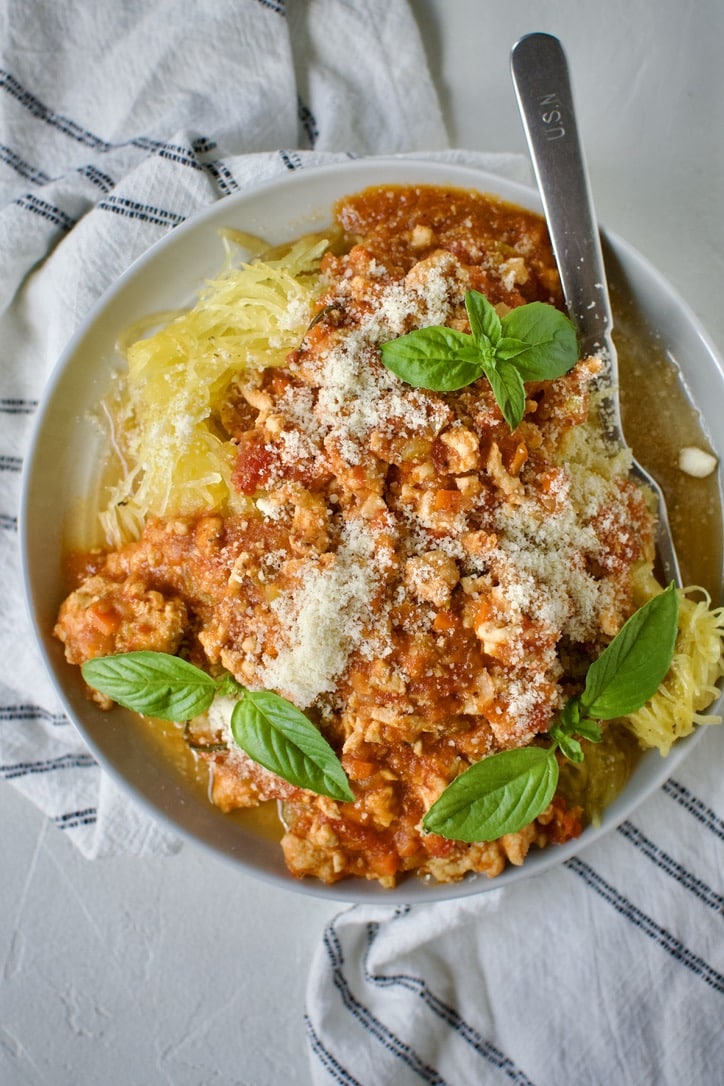 Chicken Ragu over Spaghetti Squash Nests on a plate ready to eat.