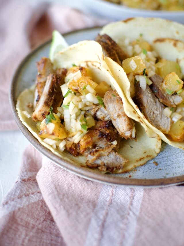 Al Pastor Taco Recipe in homemade corn tortillas topped with pineapple salsa.