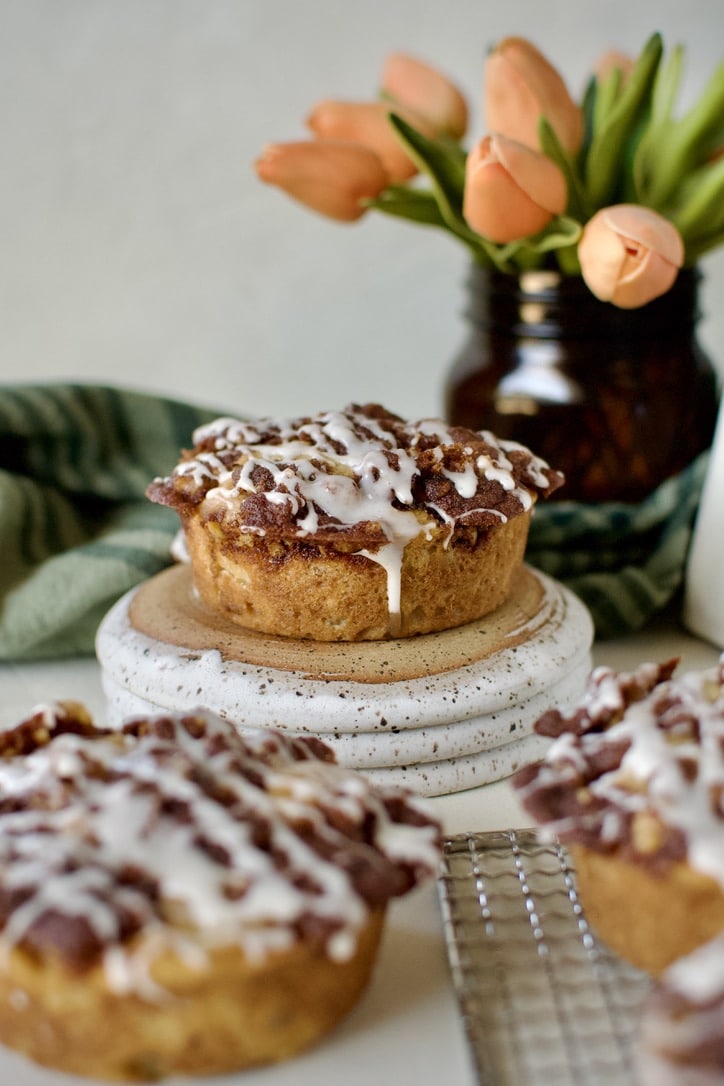 Glazed Apple Streusel Muffins on a table displayed and ready to eat.