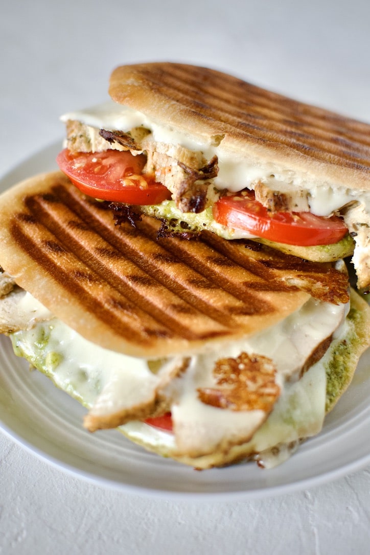 Pesto Chicken Panini, stacked on a plate, ready to eat.
